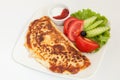 Classic omelet with cheese and tomatoes and cucumbers salad on a white plate Royalty Free Stock Photo