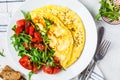 Classic omelet with cheese and tomatoes salad on white plate, top view Royalty Free Stock Photo