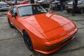 Classic orange vintage model sports car Porsche 944 1982 is presented at the retro car festival Royalty Free Stock Photo