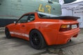 Classic orange vintage model sports car Porsche 944 1982 at a retro car show