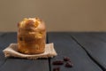 Classic panettone dessert with raisins on wooden table with space for text