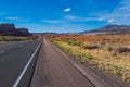 Classic panorama view of an endless straight road running through the barren scenery of the American Southwest. Royalty Free Stock Photo