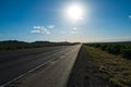 Classic panorama view of an endless straight road running through the barren scenery of the American Southwest. Royalty Free Stock Photo
