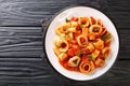 Classic Pasta Calamarata with squid sauce Italian Recipe close-up in a plate. Horizontal top view Royalty Free Stock Photo