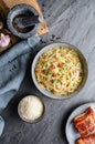 Classic pasta Carbonara, hearty Italian dish made with Spaghetti, egg, fried bacon, topped with grated Parmesan cheese and black p Royalty Free Stock Photo