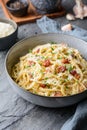 Classic pasta Carbonara, hearty Italian dish made with Spaghetti, egg, fried bacon, topped with grated Parmesan cheese and black p Royalty Free Stock Photo