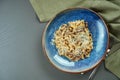 Classic pasta with wild mushrooms, cream sauce and parmesan in a blue plate on a wooden background. Top view, flat lay, copy space Royalty Free Stock Photo