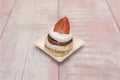a classic Pavlova, presented on a rustic wooden board, decorated simply with strawberries Royalty Free Stock Photo