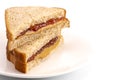 A Classic Peanut Butter and Strawberry Jelly Sandwich on Wheat B Royalty Free Stock Photo