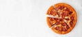 Classic pepperoni pizza with cut slices overhead on a white marble banner background Royalty Free Stock Photo