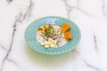 Classic Peruvian ceviche with marinated sea bass, grains of two varieties of corn, red onion, coriander, sweet potato and a