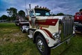 Classic peterbilt semi tractor towing an antique truck towing a truck front view