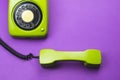 Classic phone with handset. vintage green telephone with phone receiver isolated on purple background. old communication Royalty Free Stock Photo