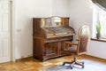 Classic piano and chair on wheels in an antique room interior. R Royalty Free Stock Photo