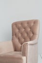 A classic pink armchair sits in a white room on a wooden floor. copy space Royalty Free Stock Photo