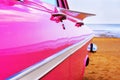 Classic pink Cadillac at beach