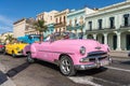 Classic pink convertible car on a tour of old Havana. Cuba.