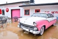 Classic pink Ford Fairlane Crown Victoria parked in front the Route 66 Place