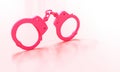 Classic pink handcuffs on a light background Royalty Free Stock Photo