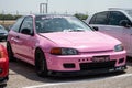 Classic pink Japanese sports car Honda Civic EG of the fifth generation at an exhibit