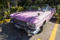 A classic pink retro car is parked on road in the resort town of Varadero. Cuba