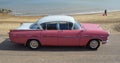 Classic Pink & White Vauxhall Cresta parked on seafront promenade.