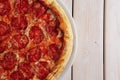 Classic pizza pepperoni on wooden background