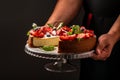 Classic plain New York Cheesecake sliced in the hands of the chef closeup view, banner menu recipe place for text