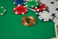 Classic playing cards, chips, red dice, bitcoin and dollars on green background. Royalty Free Stock Photo