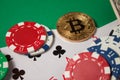 Classic playing cards, chips, red dice, bitcoin and dollars on green background. Royalty Free Stock Photo