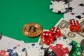Classic playing cards, chips, red dice, bitcoin and dollars on green background. Royalty Free Stock Photo