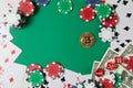 Classic playing cards, chips, red dice, bitcoin and dollars on green background. Royalty Free Stock Photo