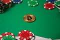 Classic playing cards, chips, red dice, bitcoin and dollars on green background. Royalty Free Stock Photo