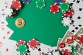 Classic playing cards, chips, red dice, bitcoin and dollars on green background. Royalty Free Stock Photo