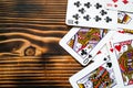 Classic playing cards on dark brown wooden table. Scattered cards. Royalty Free Stock Photo