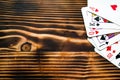 Classic playing cards on dark brown wooden table. Scattered cards.