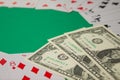 Classic playing cards and dollars on green background. Gambling and casino concept. Royalty Free Stock Photo