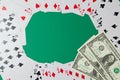 Classic playing cards and dollars on green background. Gambling and casino concept. Royalty Free Stock Photo