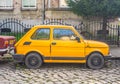 Classic Polish small car Polski Fiat 126p yellow compact parked Royalty Free Stock Photo