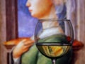 The classic portrait of the old woman by Italian artist Fra Filippo Lippi shown as an inverted reflection in a wine g