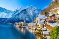 Classic postcard view of famous Hallstatt lakeside town in the Alps with traditional passenger ship on a beautiful cold sunny day Royalty Free Stock Photo