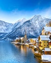 Classic postcard view of famous Hallstatt lakeside town in the Alps with traditional passenger ship on a beautiful cold sunny day Royalty Free Stock Photo