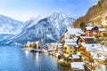 Classic postcard view of famous Hallstatt lakeside town in the Alps with traditional passenger ship on a beautiful cold sunny day Royalty Free Stock Photo