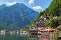 Classic postcard view of famous Hallstatt lakeside town reflecting in Hallstattersee lake in the Austrian Alps in scenic beautiful