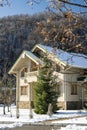 Classic postcard view of holiday cottages in the mountains on a Sunny winter day. Caucasus region Russia Royalty Free Stock Photo