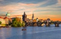 Classic Prague panorama with Old Town Bridge Tower and Charles bridge over Vltava river at sunset, Czech Republic