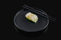 Classic raw scallop sashimi with cucumber on a stylish black ceramic plate on a black background. Japanese traditional food. Photo