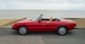 Classic Red Alpha Romeo Convertible Motor Car Parked on Seafront Promenade. Royalty Free Stock Photo