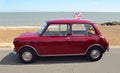 Classic Red Austin Mini motor car parked on Felixstowe seafront promenade. Royalty Free Stock Photo