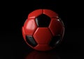 Classic red black soccer ball isolated on black background Royalty Free Stock Photo